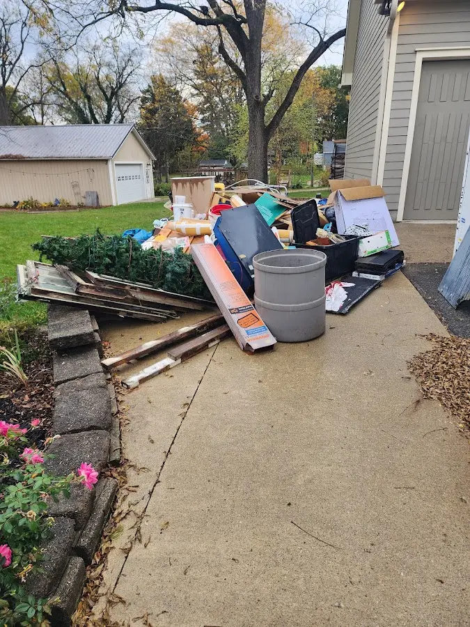 Dumpster being loaded with debris for Estate Cleanout Dumpster Rental in Livonia